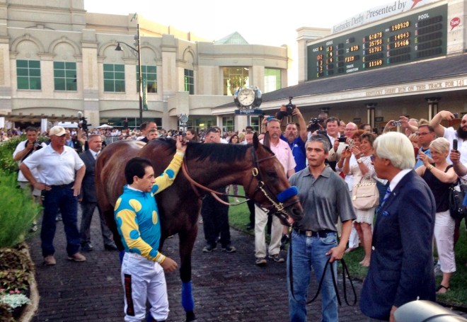 Jockey Victor Espinoza with American Pharoah in the Churchill Downs paddock as trainer Bob Baffert gets a good look at his Triple Crown winner (John Cox photo)