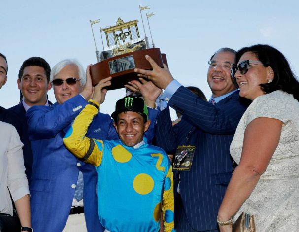 Triple Crown winner American Pharoah's trainer Bob Baffert, center left, jockey Victor Espinoza, center, and owner Ahmed Zayat, second right, and his wife, Joanne Zayat, right, hold up the winner's trophy after American Pharoah won the Haskell Invitational horse race at Monmouth Park in Oceanport, N.J., Sunday, Aug. 2, 2015. Keen Ice was second. Photo: Mel Evans, AP 